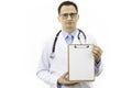 Confident handsome doctor in white coat and stethoscope holding blank clipboard Royalty Free Stock Photo