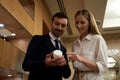 Two young people looking at the jar of cream and smiling