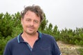 Confident handsome man on summer outdoor in sandy dune