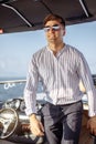 Confident handsome yacht owner settles his business issues while sailing in sea