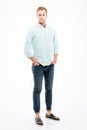 Confident handsome young man standing with hands in pockets Royalty Free Stock Photo