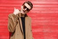 Confident handsome young man in sunglasses showing telephone gesture Royalty Free Stock Photo