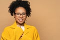 Confident happy African American young woman in yellow cardigan wearing spectacles, looking at camera. Smiling mixed race girl Royalty Free Stock Photo