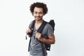 Confident and happy african young man with backpack smiling looking at camera ready to go hitchhiking or just hiking in Royalty Free Stock Photo