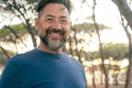 Confident happy cheerful man portrait smiling and looking on camera. Trees nature park in background. People enjoying outdoor Royalty Free Stock Photo