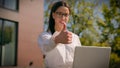 Confident happy hispanic woman businesswoman freelancer business lady student working on laptop outdoors showing thumb Royalty Free Stock Photo