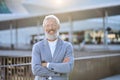 Confident happy mature older business man standing outdoors, portrait. Royalty Free Stock Photo