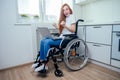 Confident happy redhaired ginger businesswoman student in wheelchair working at office