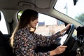 Confident and happy young brunette lady driving in a car Royalty Free Stock Photo