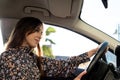 Confident and happy young brunette lady driving in a car Royalty Free Stock Photo