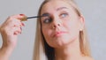 Confident happy young woman holding mascara apply on eyeleashes prepare getting ready in the morning, smiling beautiful Royalty Free Stock Photo