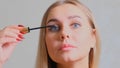 Confident happy young woman holding mascara apply on eyeleashes prepare getting ready in the morning, smiling beautiful Royalty Free Stock Photo