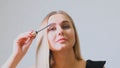 Confident happy young woman holding mascara apply on eyeleashes prepare getting ready in the morning, smiling beautiful Royalty Free Stock Photo