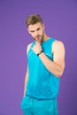 Confident in his fitness regime. Man sporty outfit looks confident and motivated for training, violet background. Stay