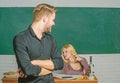 Confident in his knowledge. Handsome man standing hands crossed in classroom with teacher. Male student with examiner at