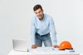 Confident in his new project. young engineer and architect man working on laptop and looking at camera with smile while Royalty Free Stock Photo