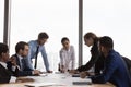 Confident Indian business leader and diverse team discussing paper reports Royalty Free Stock Photo