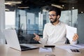 Confident indian businessman in office working on laptop with a warm smile Royalty Free Stock Photo