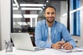 Smiling Indian businessman working in a modern office Royalty Free Stock Photo