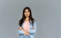 Confident indian young woman look at camera isolated on grey studio background