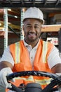 Confident Industrial Worker Driving Forklift At Workplace Royalty Free Stock Photo