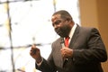 Confident and influential business leader, Les Brown, speaks at a professional conference