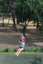 Confident joyful woman climbing in rope park