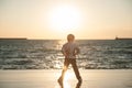 Confident kid on the background of beautiful sea sunset