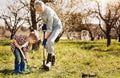 Confident kid helping his grandfather in the garden Royalty Free Stock Photo