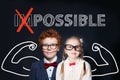 Confident kids little boy and girl with text possible on chalkboard background. Success and develop concept
