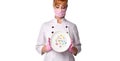 Confident lady doctor in medical mask holding plate with pills in assortment pointing index finger up. Royalty Free Stock Photo