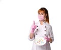 Confident lady doctor in medical mask holding plate with pills in assortment pointing index finger up. Waist-up shot isolated on Royalty Free Stock Photo