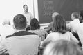 Confident lecturer talking to mixed age students