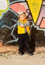 Confident little boy posing in front of graffiti Royalty Free Stock Photo
