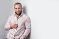 Confident looking business man in flamboyant shirt walks down a staircase