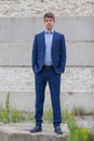 Confident male business teenager in blue suit