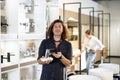 Confident male customer choosing bathroom faucet in store Royalty Free Stock Photo