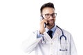 Confident male doctor making a call while standing at isolated white background Royalty Free Stock Photo