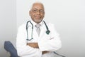 Confident Male Doctor Standing With Hands Folded Royalty Free Stock Photo