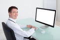 Confident Male Doctor Working On Computer At Desk Royalty Free Stock Photo
