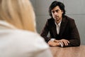Confident male hr manager in suit, employer holding interview with job applicant, employment. Focused woman looking at Royalty Free Stock Photo