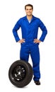 Confident Male Mechanic With Spare Tire Royalty Free Stock Photo