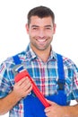 Confident male repairman holding monkey wrench Royalty Free Stock Photo