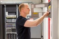 Confident Male Technician Checking Fire Panel In Datacenter