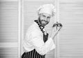 Confident man in apron and hat hold tray. cook in restaurant, uniform. bearded man loves eating food. chef ready for