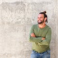 Confident man with beard standing against wall