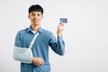 A confident man copes with a broken arm, using credit card Royalty Free Stock Photo