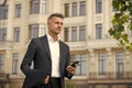 Confident man formal outfit. modern life concept. businessman on way to office. agile business. use phone while walking Royalty Free Stock Photo