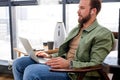 Confident man in cozy room, using laptop, watching movie, chatting on social network