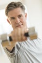 Confident Man Lifting Weights At Health Club Royalty Free Stock Photo